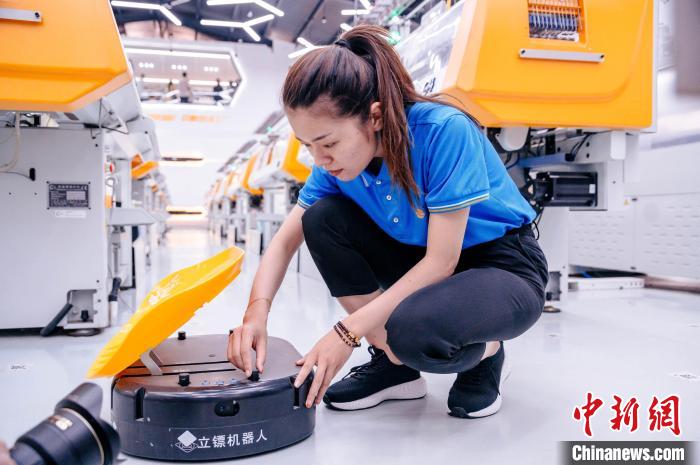 圖為員工在調(diào)試AGV搬運機器人。　李南軒 攝